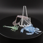 Glitter bomb fishing bait set with clear stand and pink and blue glitter lure pieces