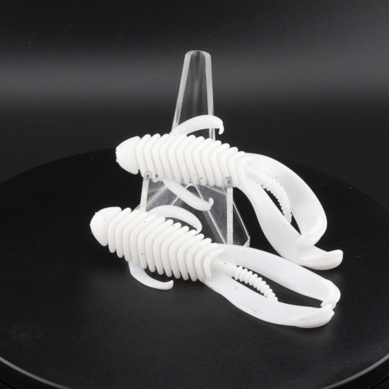 3.25-inch white soft plastic creature lure on clear display stand, ribbed body