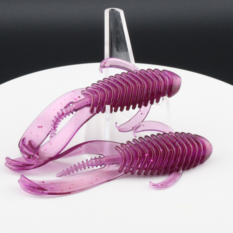 Translucent purple soft plastic fishing bait worms with ridged tails