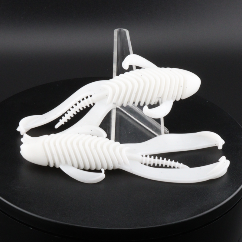 White soft plastic creature lures with ribbed bodies and curled tails