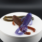 Purple and brown speckled soft plastic creature lures, ribbed bodies with tails