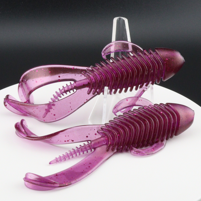 Purple translucent soft plastic fishing bait worms, ridged bodies and curved tails