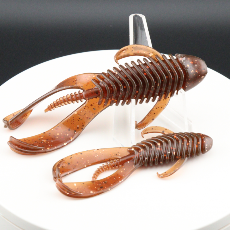 Soft plastic creature baits in orange-brown speckled color, 3.25–4.25 in
