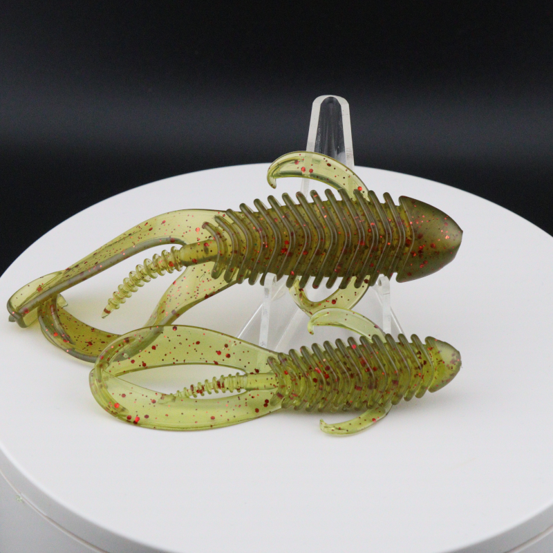 Soft plastic creature baits in olive green with red speckles, 3.25–4.25 in