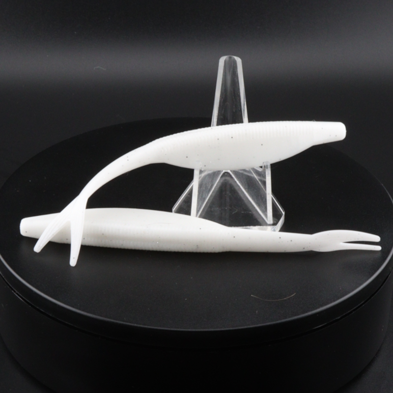 5-inch white soft plastic fluke paddle-tail lure with forked tail, side view