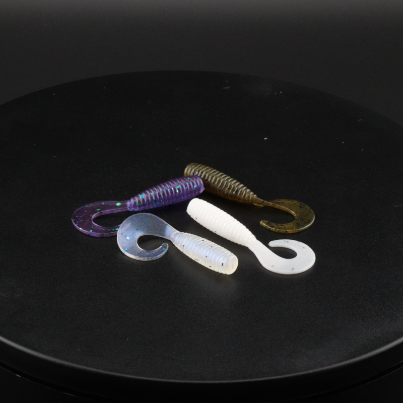 Purple-blue and white 2-inch grub soft plastic baits with curled tails