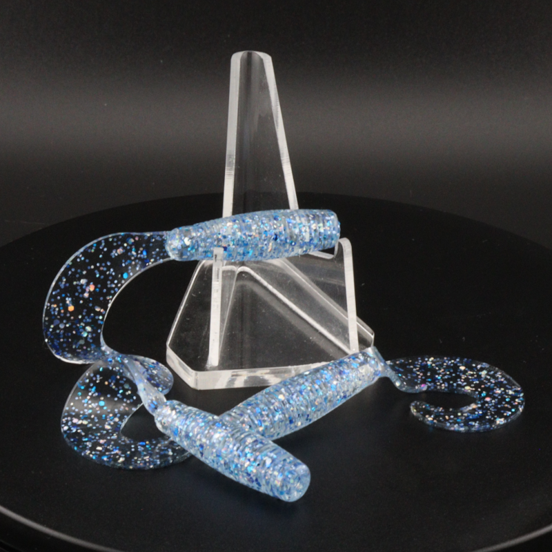 Glitter bomb fishing bait set with clear stand and blue glitter lure pieces
