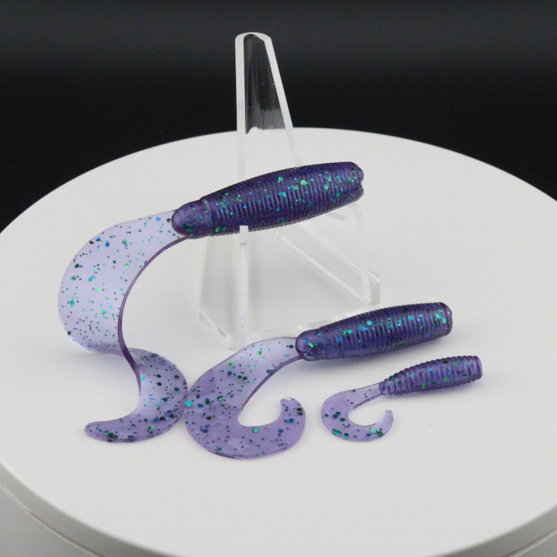 Go-to Grub soft fishing lures in purple-blue speckled color, worm-shaped with curly tails