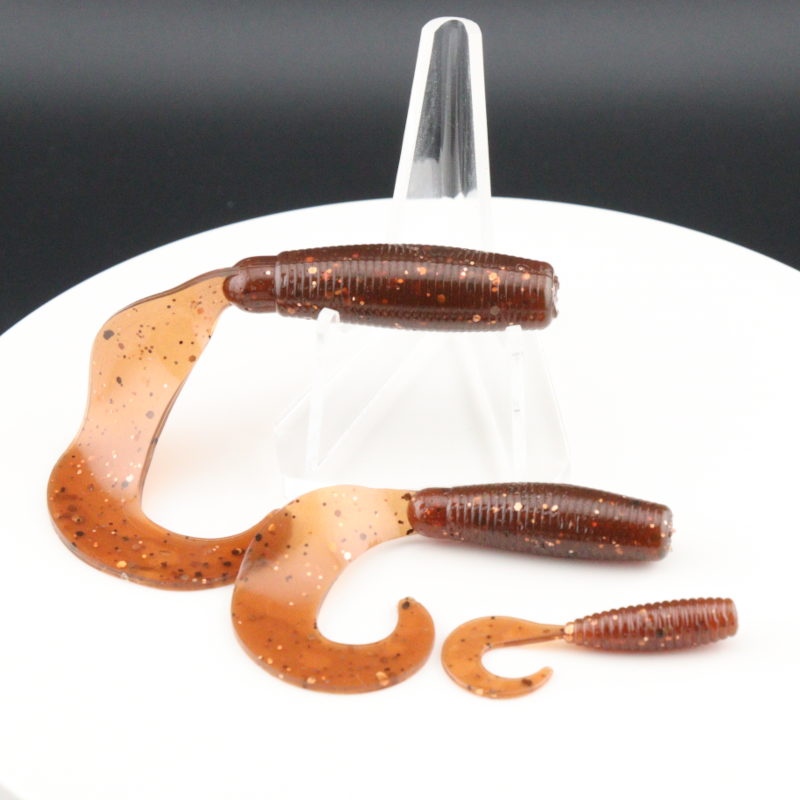 Go-to Grub soft fishing lures in brown-orange speckled color, worm-shaped with curly tails