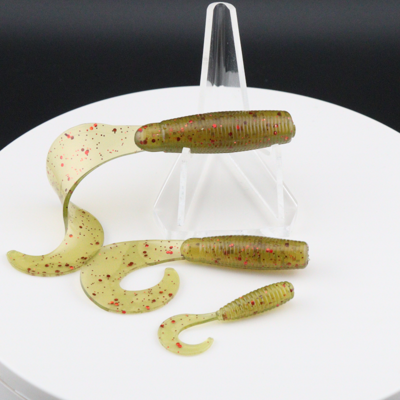 Go-to Grub soft fishing lures in olive green with red speckles, worm-shaped with curly tails