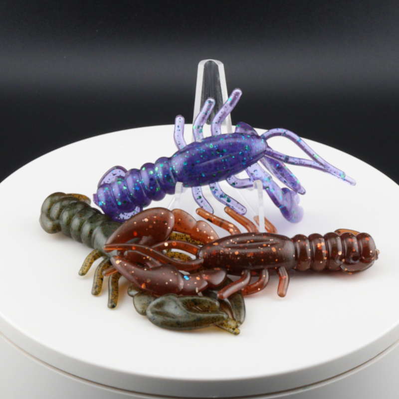 3.4-inch soft plastic craw lure set in purple, brown, and green, with curled claws