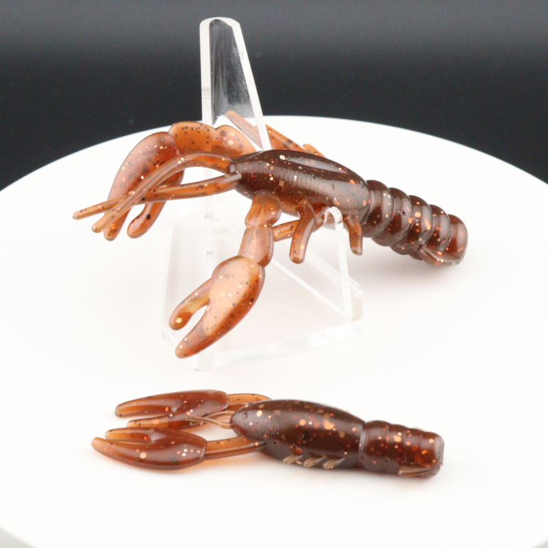 Orange and brown speckled soft plastic craw bait with curled claws
