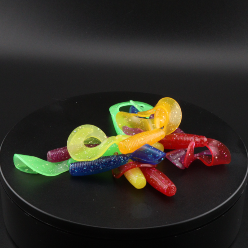 Stack of multicolor soft plastic grubs, 3-inch fishing lures