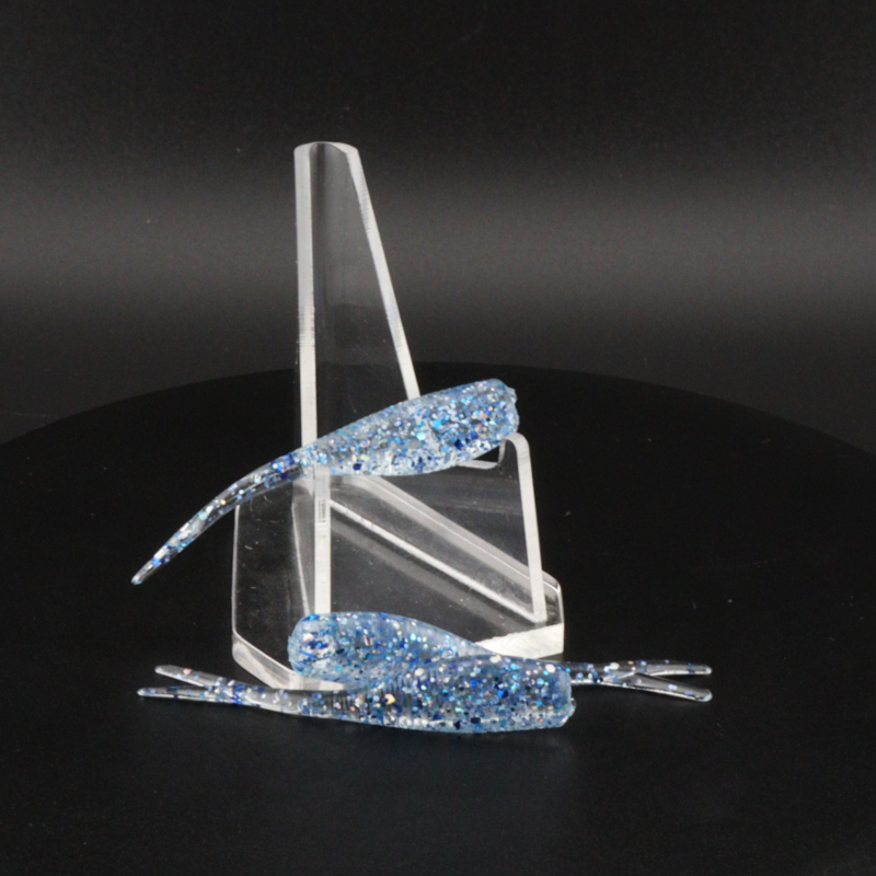 Glitter bomb fishing bait set with clear stand and light blue glitter lure pieces