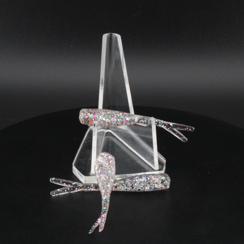 Glitter bomb fishing bait set with clear stand and pink-silver glitter lure pieces