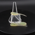 Fishing lure baits in clear stand, translucent green with speckled bodies