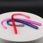 Straight tail worm lure, 5.8-inch, red and pink with glitter specks