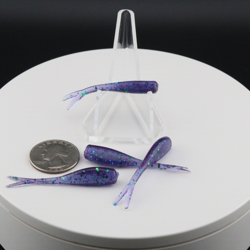 Purple glitter 2-inch soft fishing lures with paddle tails in clear holder