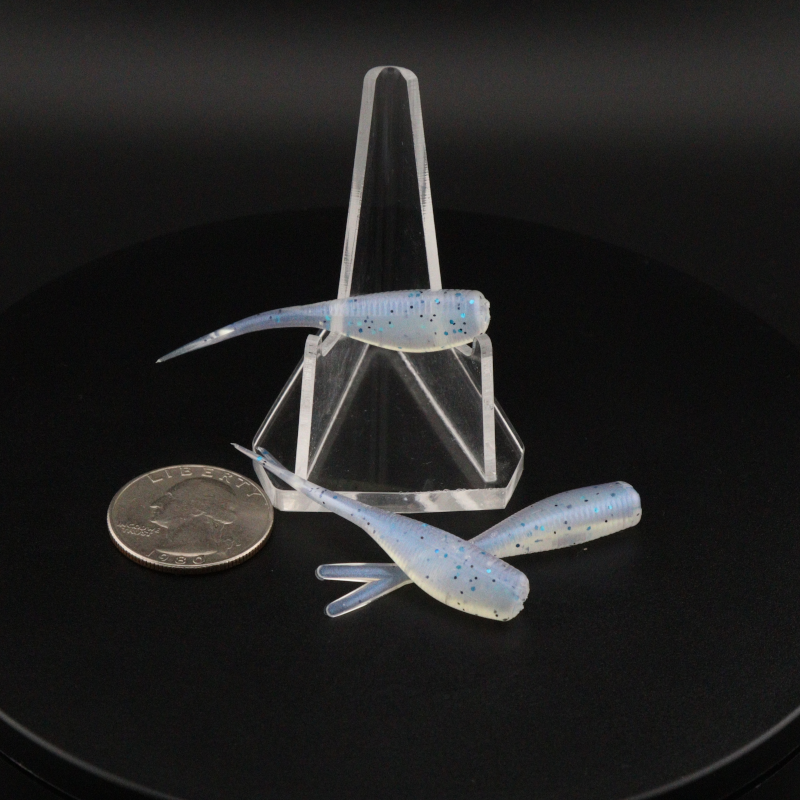 Light blue speckled 2-inch soft fishing lures with paddle tails in clear holder