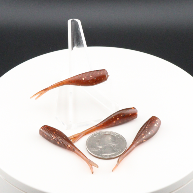 Cinnamon brown 2-inch soft fishing lures with slender paddle tails in clear holder