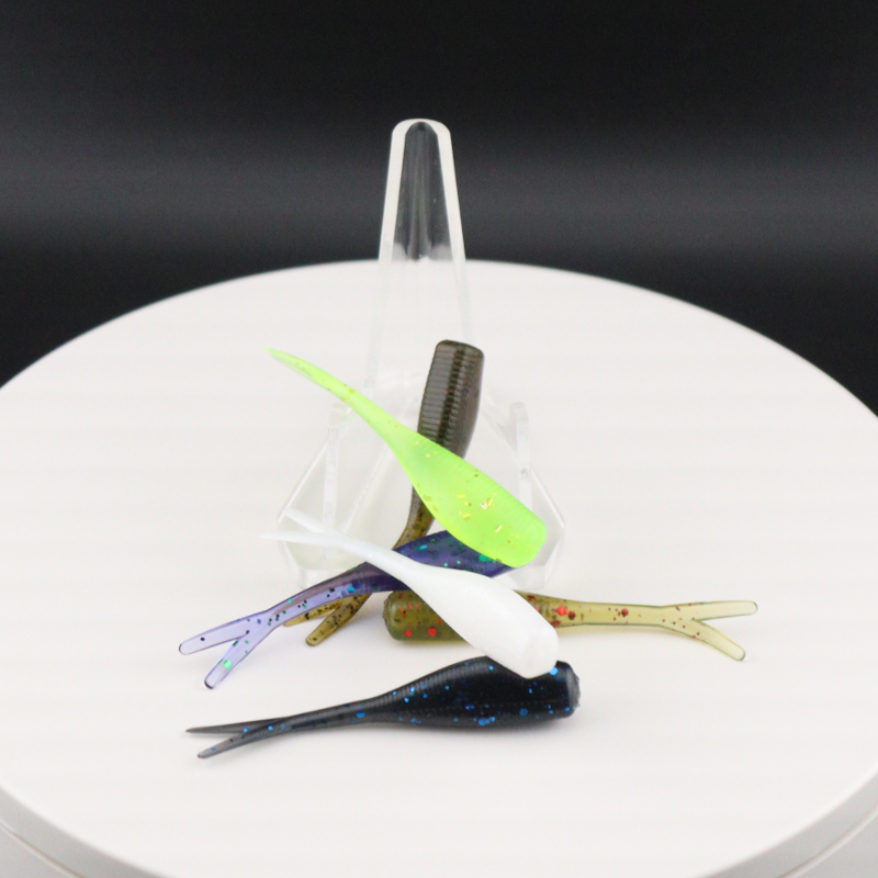 Colorful 2-inch soft fishing lures with paddle tails in clear plastic holder