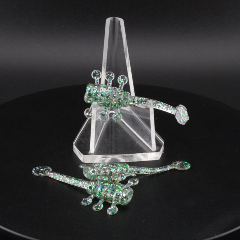 Glitter bomb fishing bait set with clear stand and green glitter lure pieces