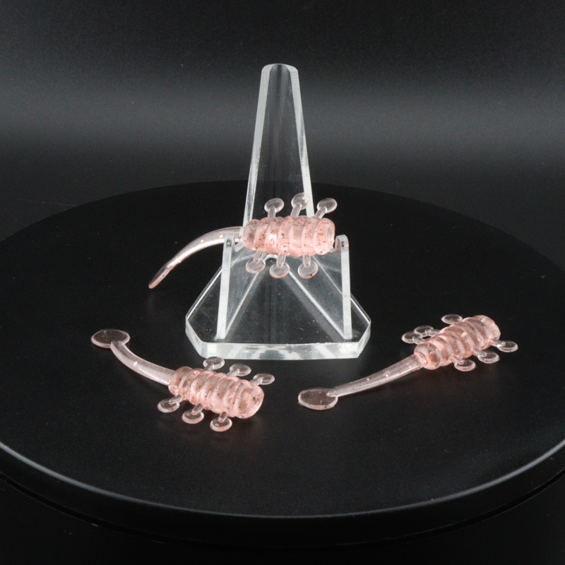 Translucent pink fishing lure with curled multi-tail arms on a clear holder